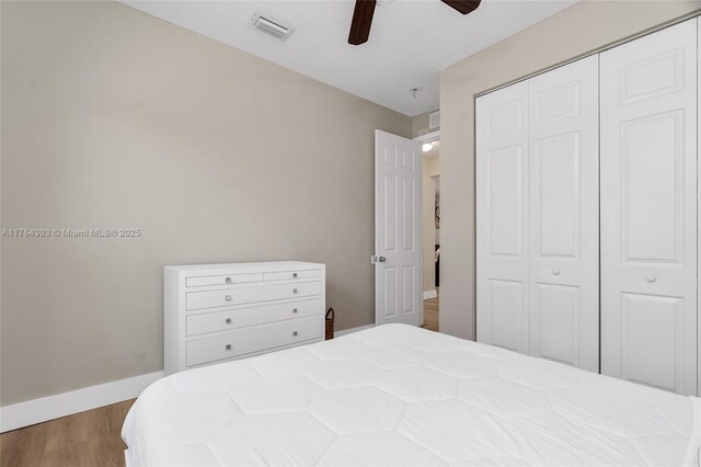 84 Belle Grove Ln, Royal Palm Beach, FL 33411 - bedroom featuring a closet, wood finished floors, baseboards, and a ceiling fan