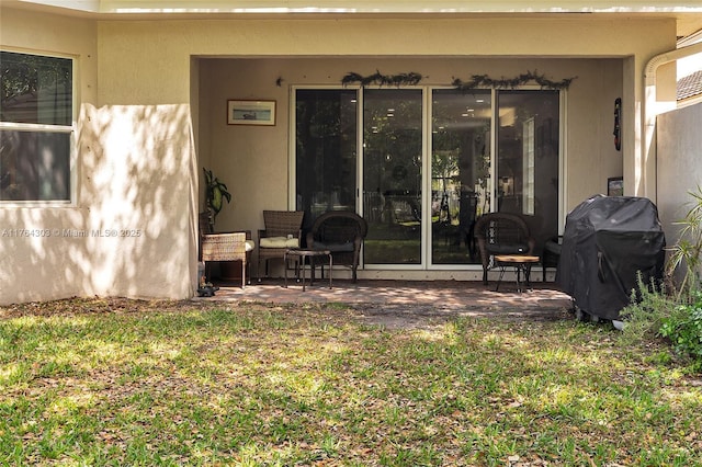 exterior space featuring a patio area and stucco siding