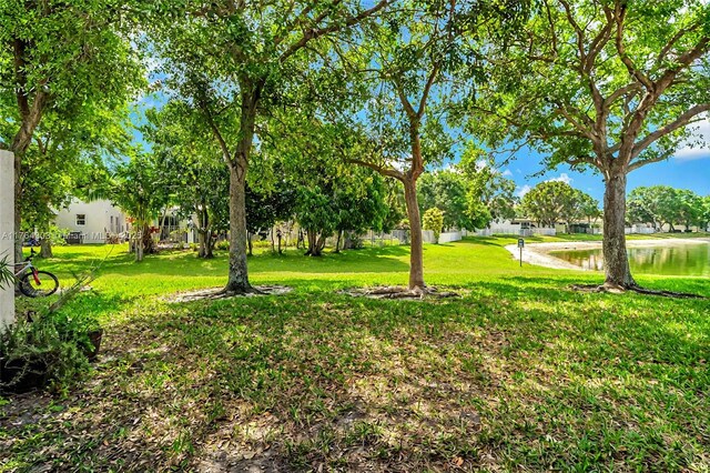 84 Belle Grove Ln, Royal Palm Beach, FL 33411 - view of grassy yard featuring a water view