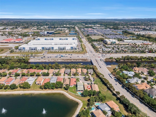 drone / aerial view with a residential view and a water view