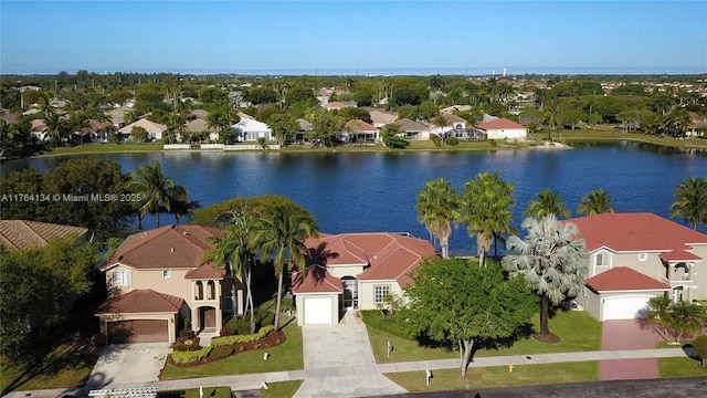 birds eye view of property featuring a residential view and a water view