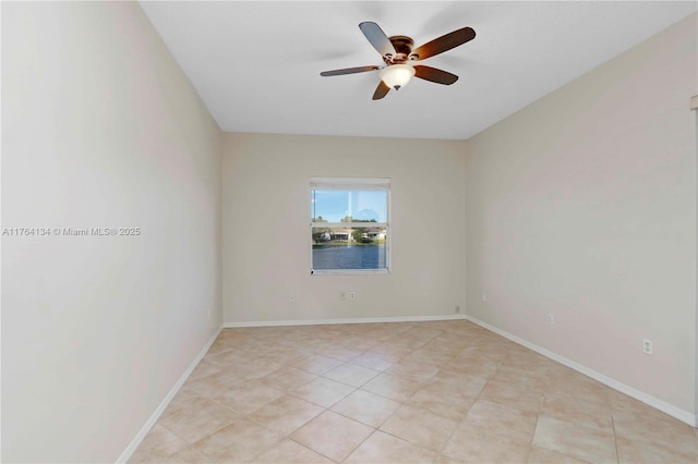 unfurnished room with light tile patterned floors, baseboards, and ceiling fan