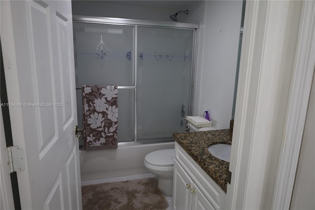 full bathroom with combined bath / shower with glass door, toilet, and vanity