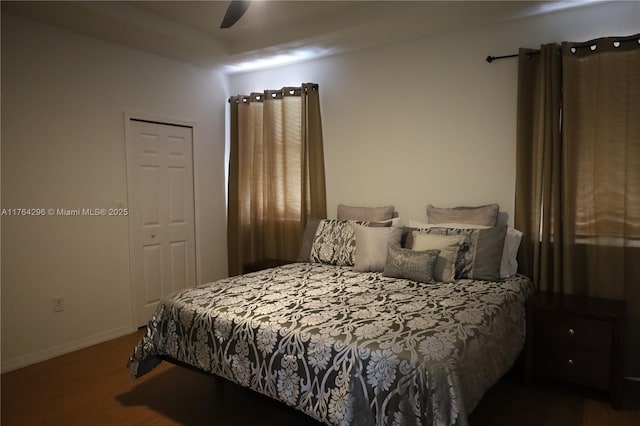 bedroom with a ceiling fan, baseboards, and wood finished floors