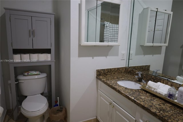 bathroom featuring vanity and toilet