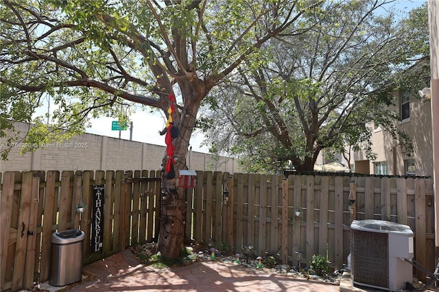 exterior space with central air condition unit and fence