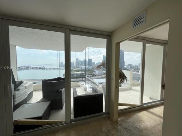 555 NE 15th St Unit 28J, Miami, FL 33132 - doorway featuring concrete flooring, a water view, a city view, and floor to ceiling windows