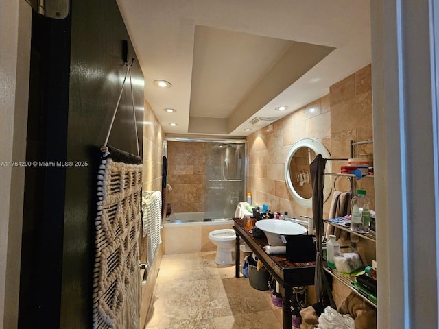555 NE 15th St Unit 28J, Miami, FL 33132 - full bathroom with tile walls, toilet, shower / washtub combination, recessed lighting, and a sink