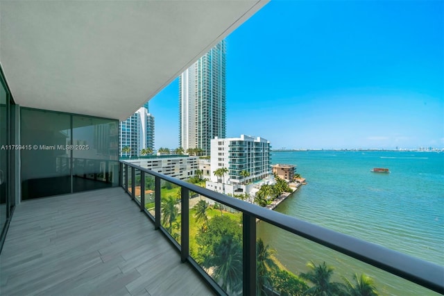 balcony featuring a view of city and a water view