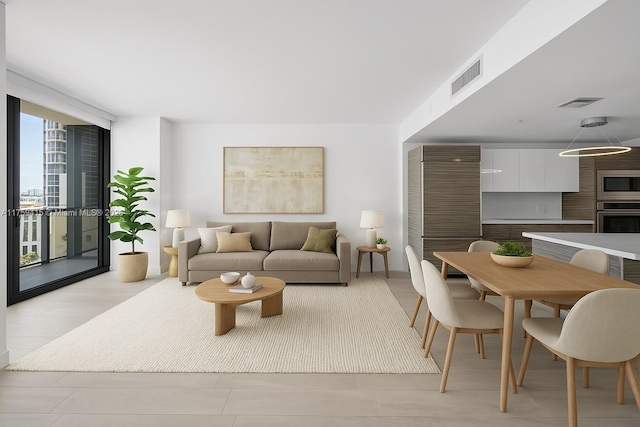 living room featuring expansive windows and visible vents