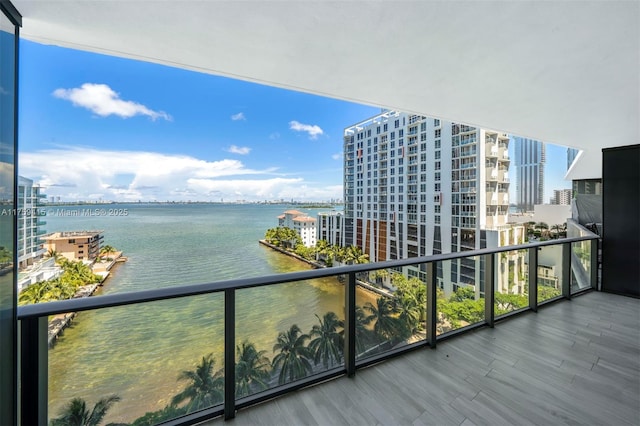 balcony featuring a view of city and a water view