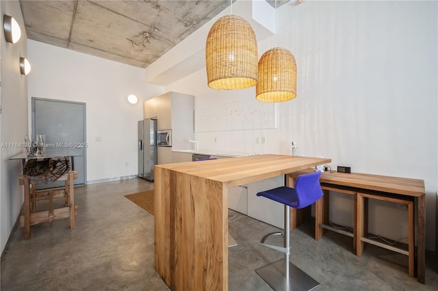 kitchen with stainless steel appliances and finished concrete floors