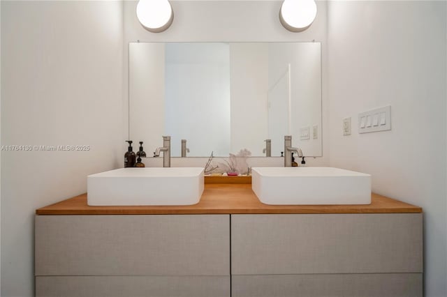 full bath with double vanity and a sink