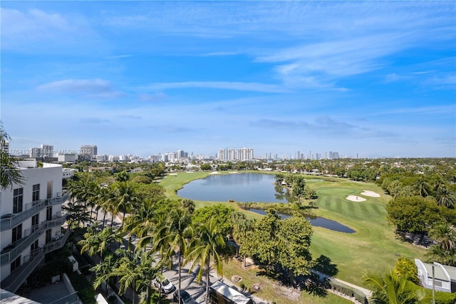 drone / aerial view with view of golf course, a water view, and a city view