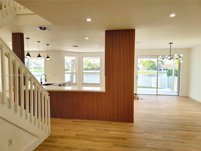 kitchen with plenty of natural light, recessed lighting, light wood finished floors, and pendant lighting