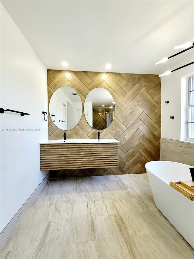 full bath featuring double vanity, recessed lighting, tiled shower, a freestanding tub, and marble finish floor