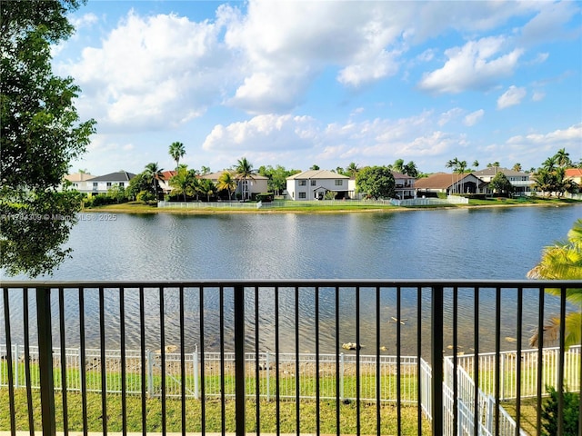 view of water feature with fence and a residential view