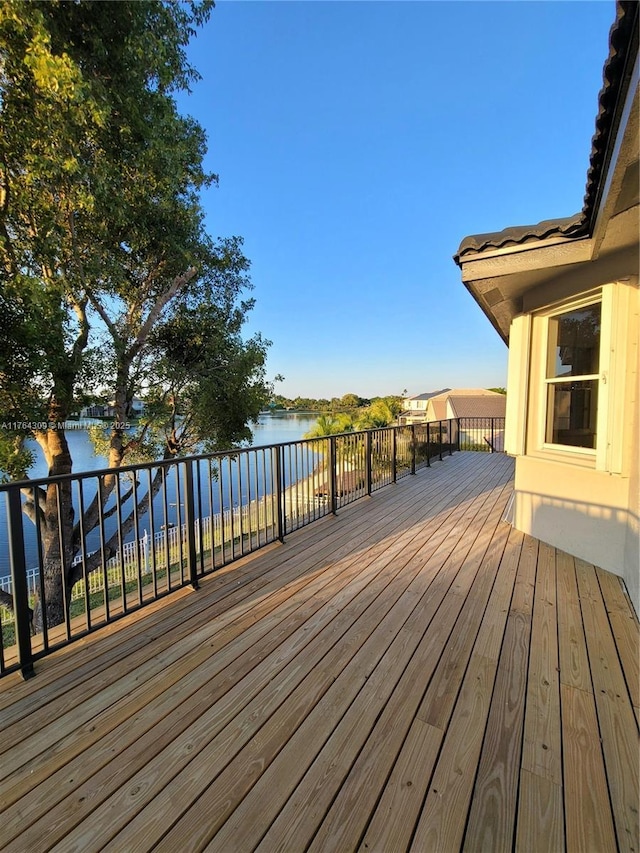 wooden deck featuring a water view