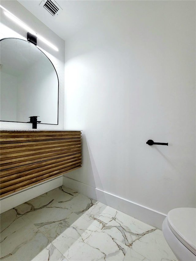 bathroom with visible vents, toilet, marble finish floor, baseboards, and vanity