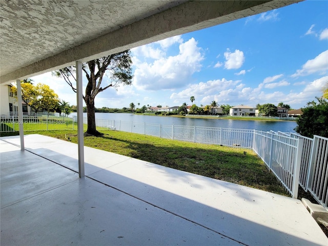 view of patio with a fenced backyard and a water view