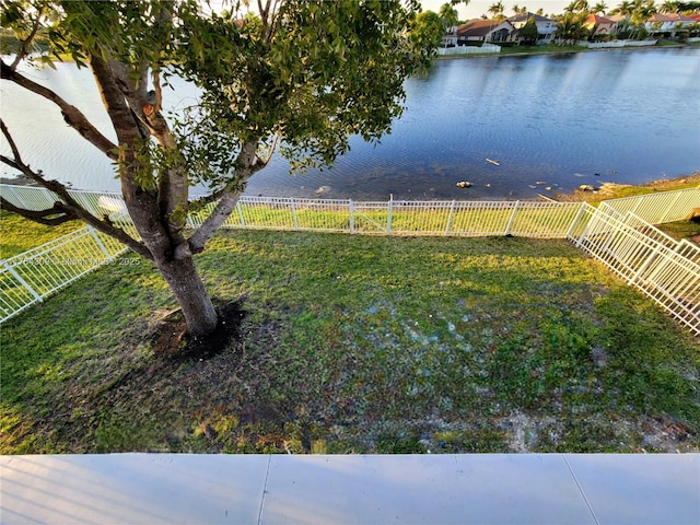 view of yard featuring fence and a water view