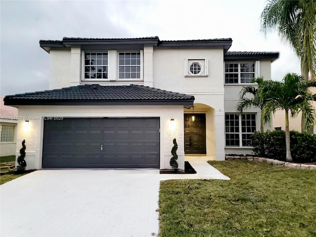 mediterranean / spanish-style home featuring a tile roof, a front yard, stucco siding, driveway, and an attached garage