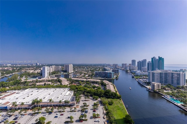 birds eye view of property featuring a city view and a water view