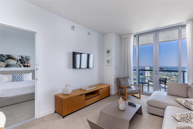 2602 E Hallandale Beach Blvd Unit R3004, Hallandale Beach, FL 33009 - living area featuring floor to ceiling windows, light colored carpet, and baseboards