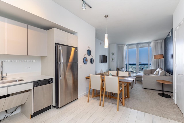 2602 E Hallandale Beach Blvd Unit R3004, Hallandale Beach, FL 33009 - kitchen with stainless steel appliances, a sink, light countertops, open floor plan, and pendant lighting