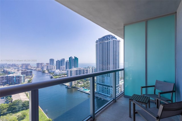 balcony featuring a view of city and a water view