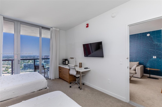 bedroom featuring a wall of windows, baseboards, and carpet floors