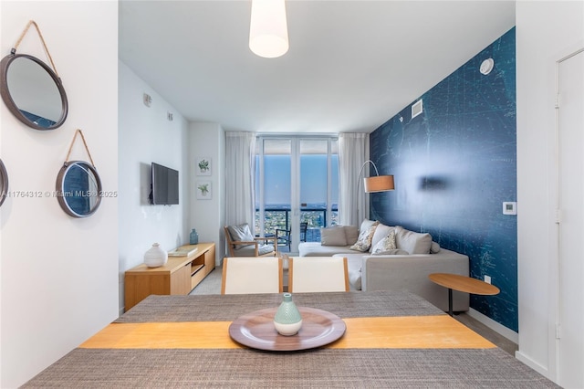 dining space with a wall of windows and visible vents