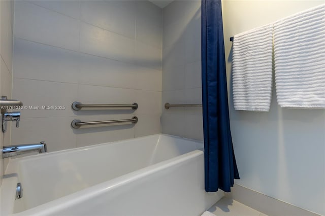 bathroom with curtained shower and a bathing tub