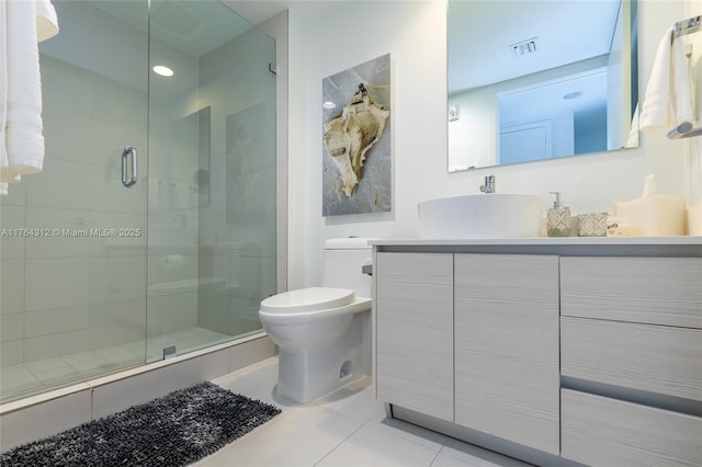 full bathroom with visible vents, toilet, a stall shower, tile patterned flooring, and vanity