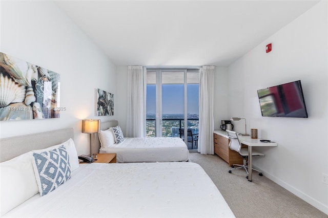 bedroom featuring floor to ceiling windows, access to outside, light colored carpet, and baseboards