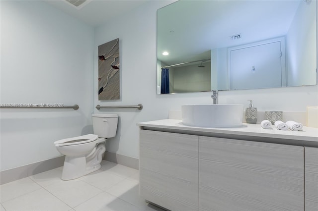 bathroom featuring vanity, baseboards, visible vents, tile patterned floors, and toilet