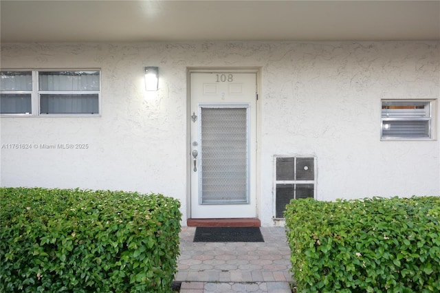 doorway to property with stucco siding