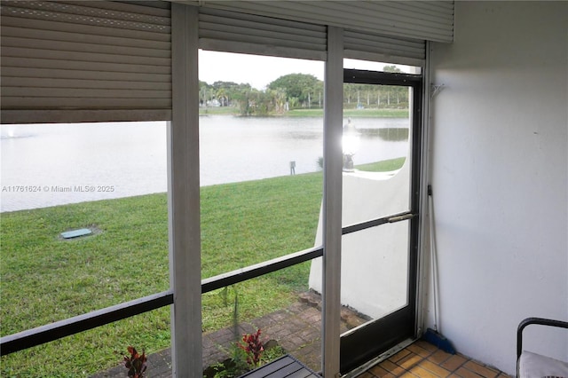 unfurnished sunroom with a water view