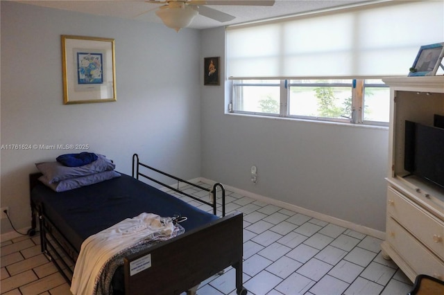 bedroom featuring a ceiling fan and baseboards