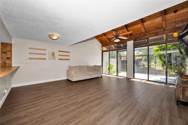 unfurnished room with a ceiling fan, a textured ceiling, wood finished floors, baseboards, and vaulted ceiling