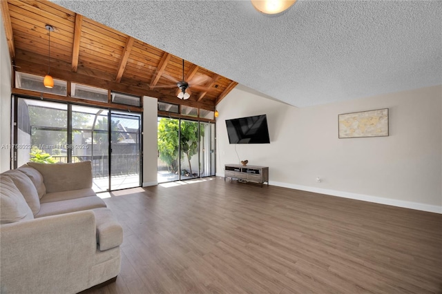 unfurnished living room with wood finished floors, wooden ceiling, baseboards, ceiling fan, and vaulted ceiling with beams