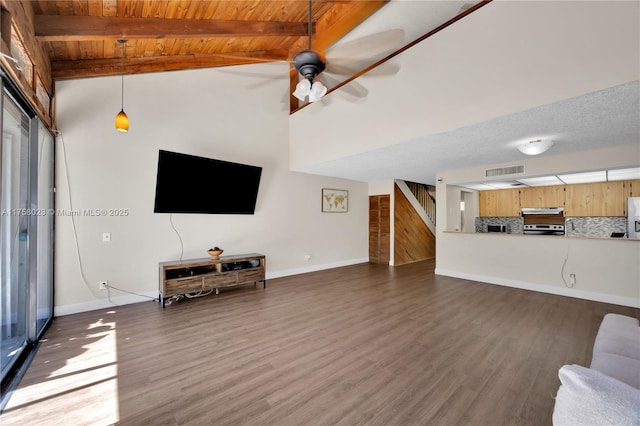 unfurnished living room with visible vents, stairs, a ceiling fan, and wood finished floors