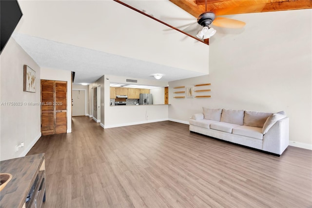 unfurnished living room with baseboards, a ceiling fan, and wood finished floors