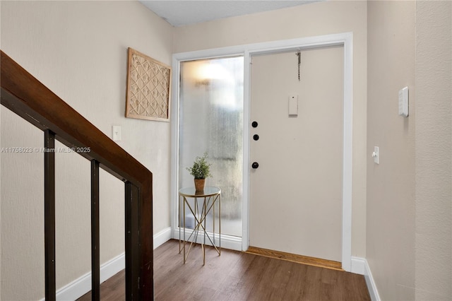 entryway featuring wood finished floors and baseboards