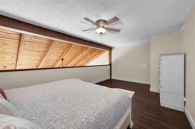 bedroom featuring visible vents, a textured ceiling, dark wood-style floors, baseboards, and vaulted ceiling with beams