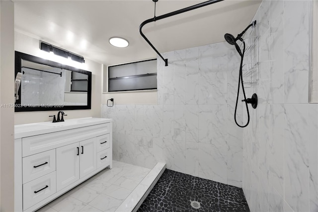 bathroom with a marble finish shower, marble finish floor, and vanity