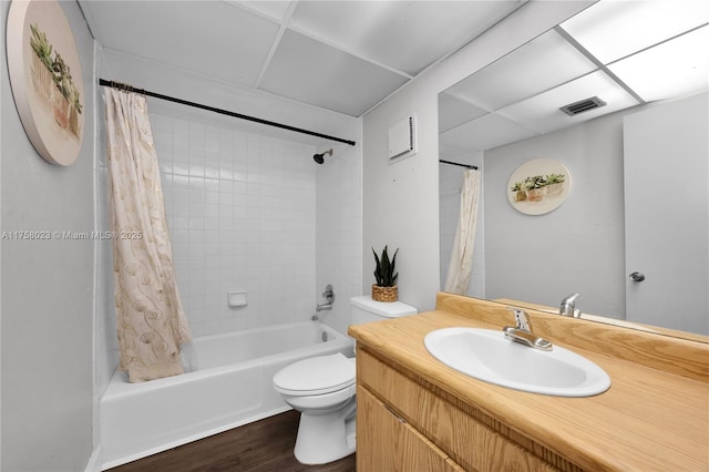 bathroom with visible vents, shower / bathtub combination with curtain, toilet, wood finished floors, and vanity