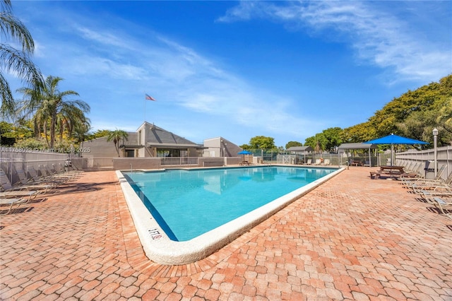 community pool featuring a patio and fence