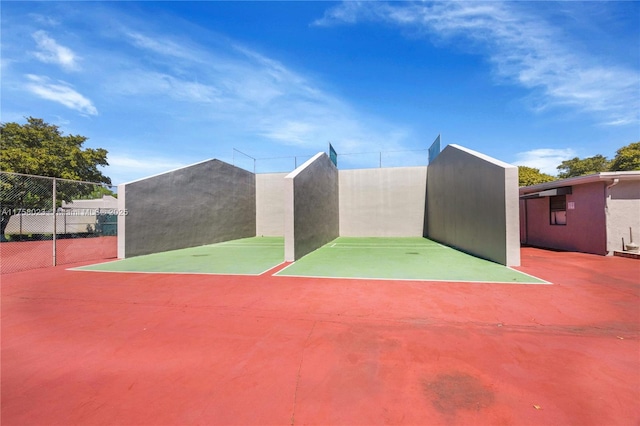 view of basketball court with fence