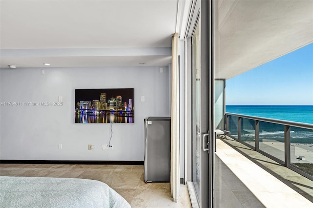 bedroom featuring freestanding refrigerator, baseboards, and a water view